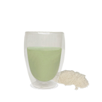 NutriBrown Rice 100% Plant-Based Prebiotic Drink in Avocado flavour, poured into a cup with the powder beside it.
