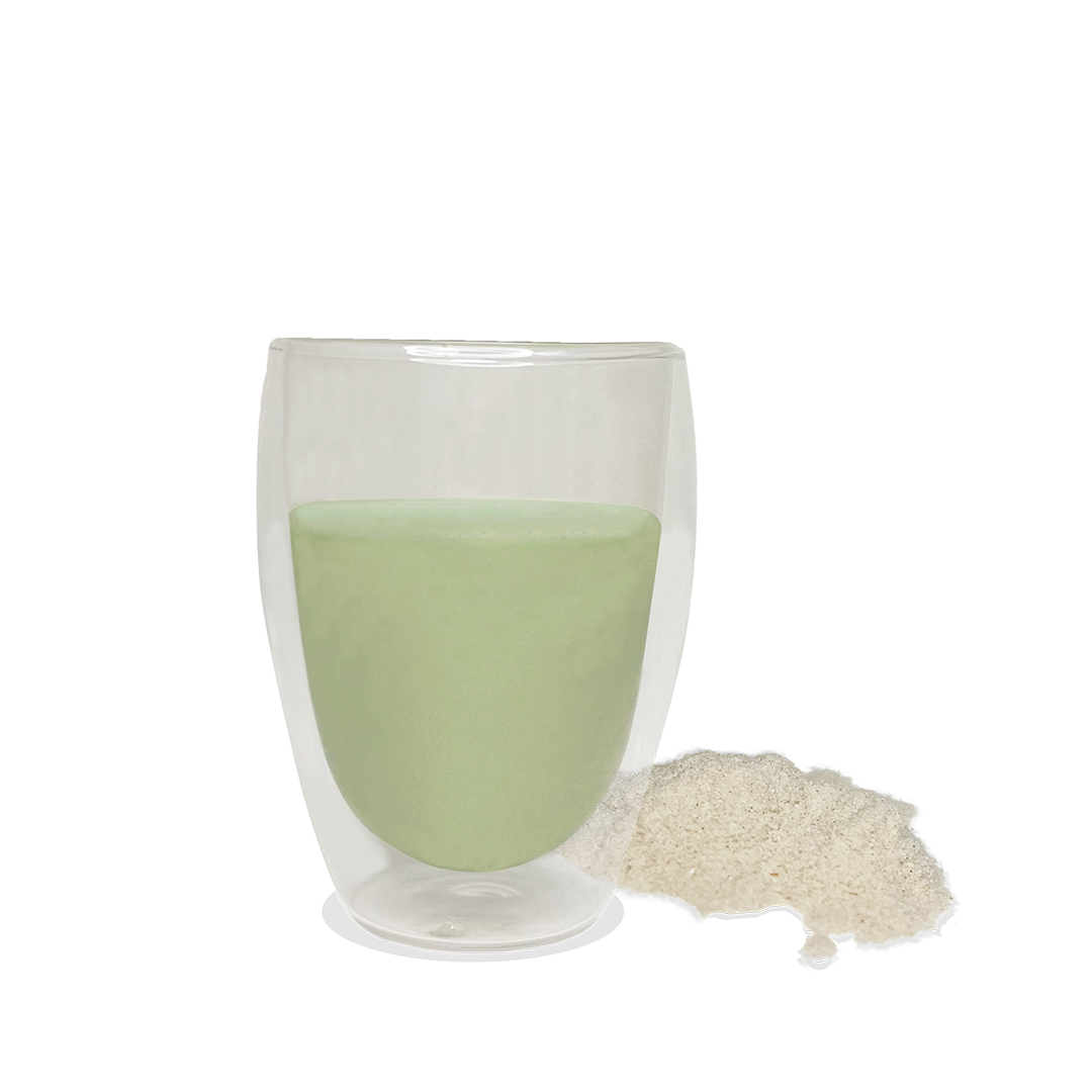 NutriBrown Rice 100% Plant-Based Prebiotic Drink in Avocado flavour, poured into a cup with the powder beside it.